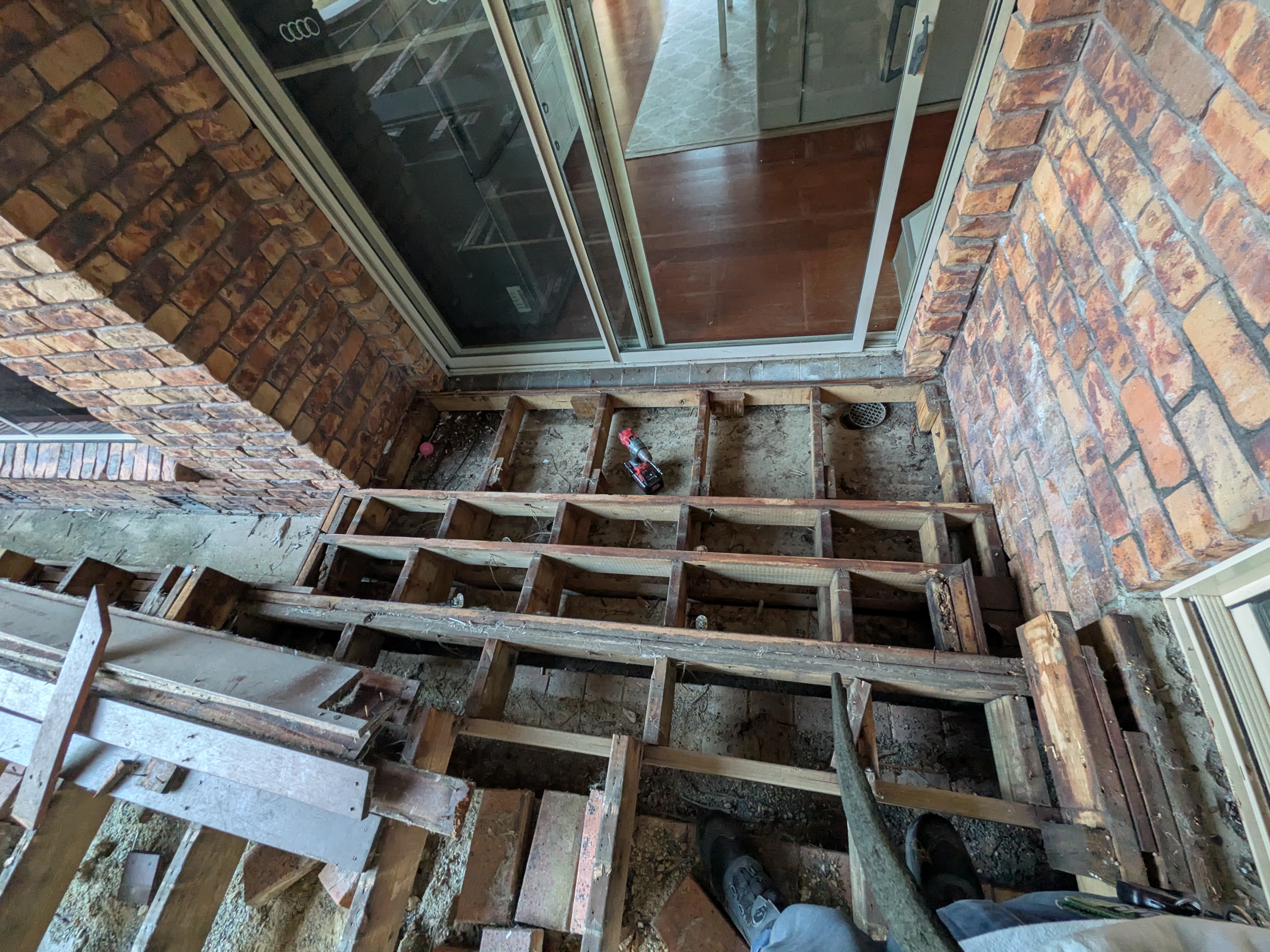 Deck joists exposed next to house, ready for new build