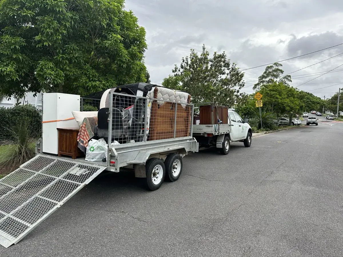 Bin Chicken Co. ute and trailer loaded with household furniture for removal on the Gold Coast